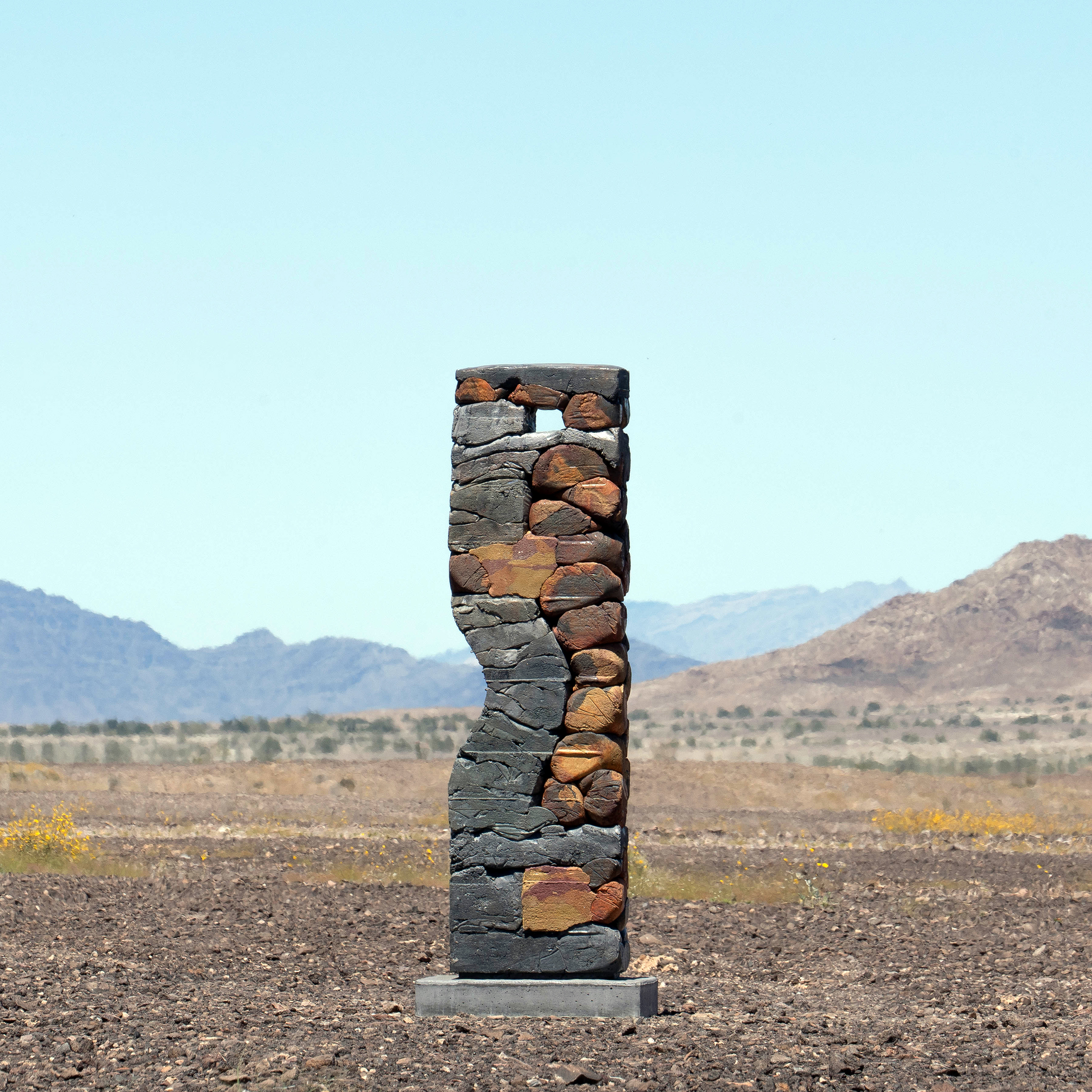 stacked concrete sculpture in southwest landscape