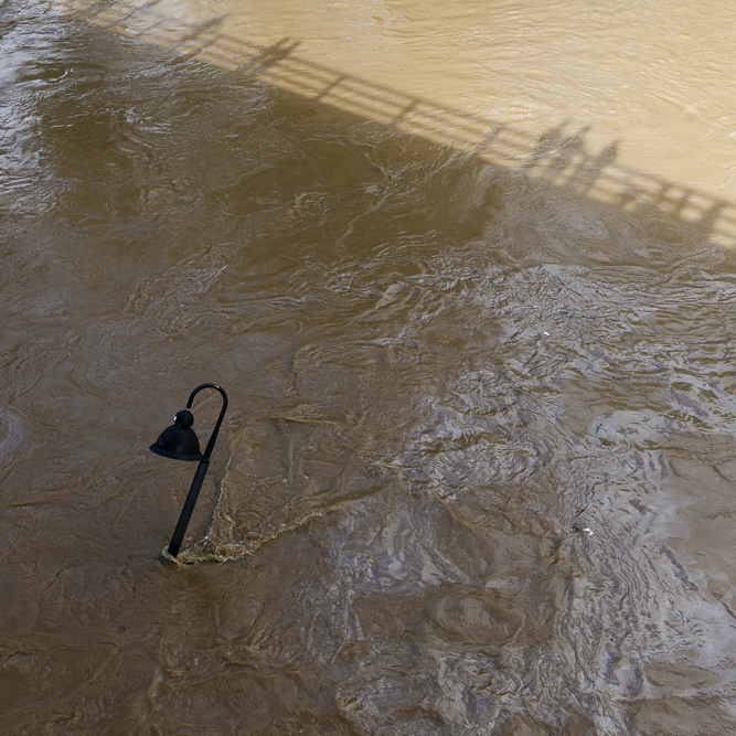 Shadows of  residents in the flooded French Broad River