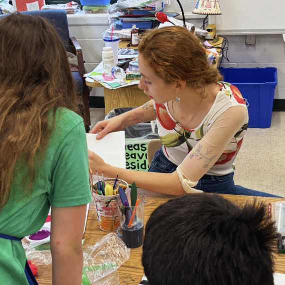 student working with workshop participants