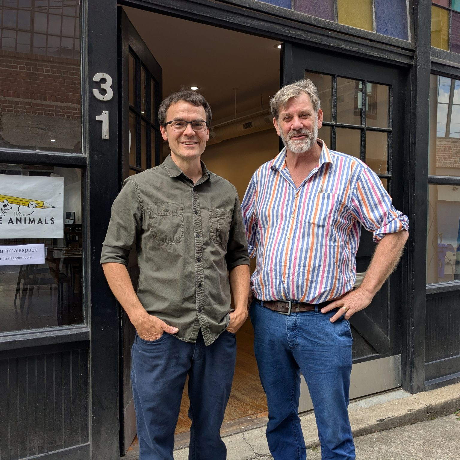 two men in front of Little Animals space downtown Asheville