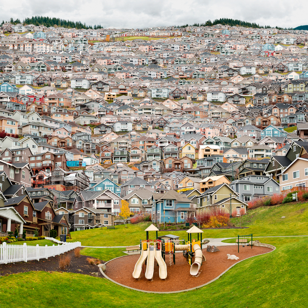 thousands of suburban homes stacked on hillside with playground