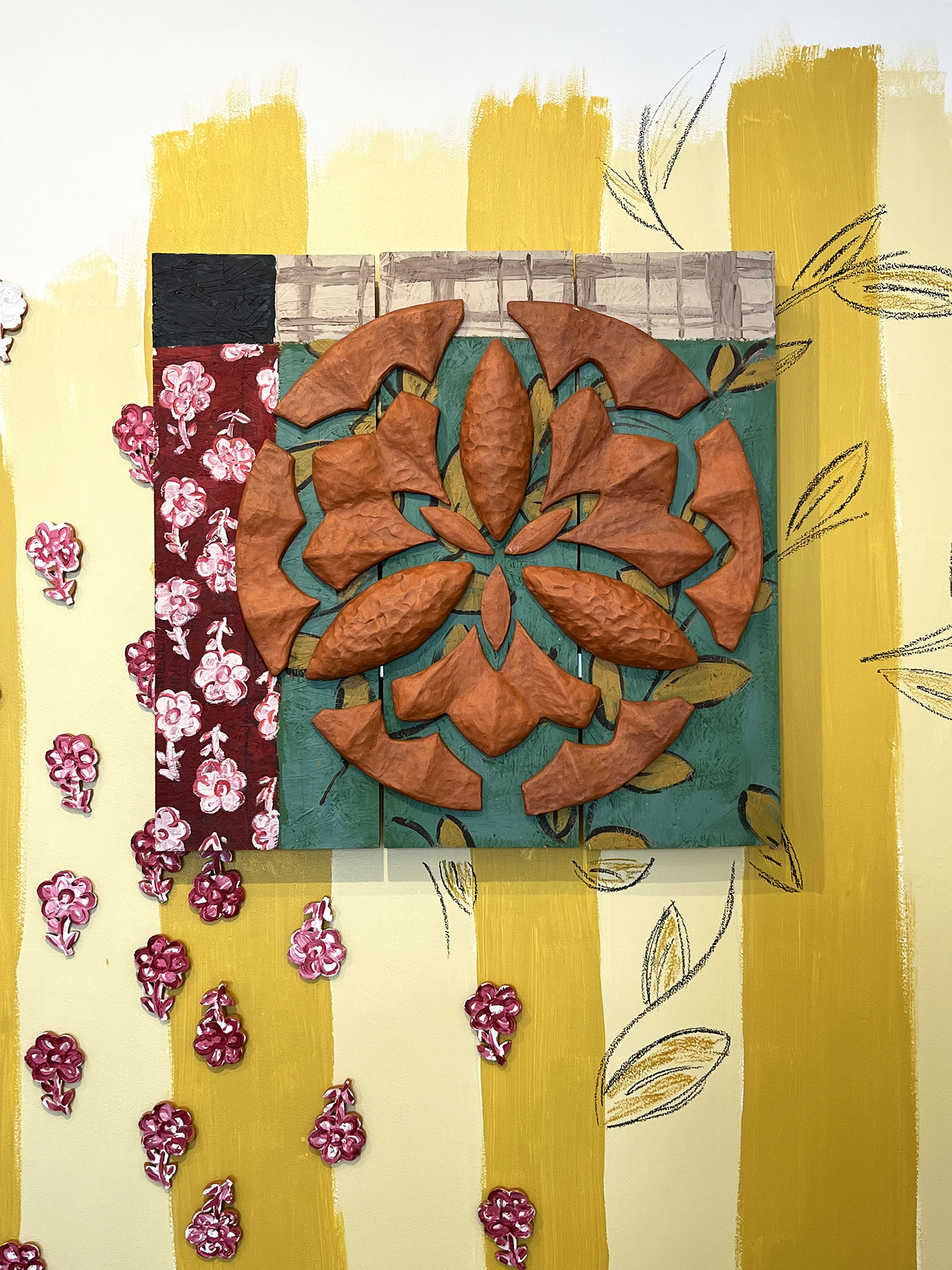 detail shot of installation with ceramic quilt pattern on wall