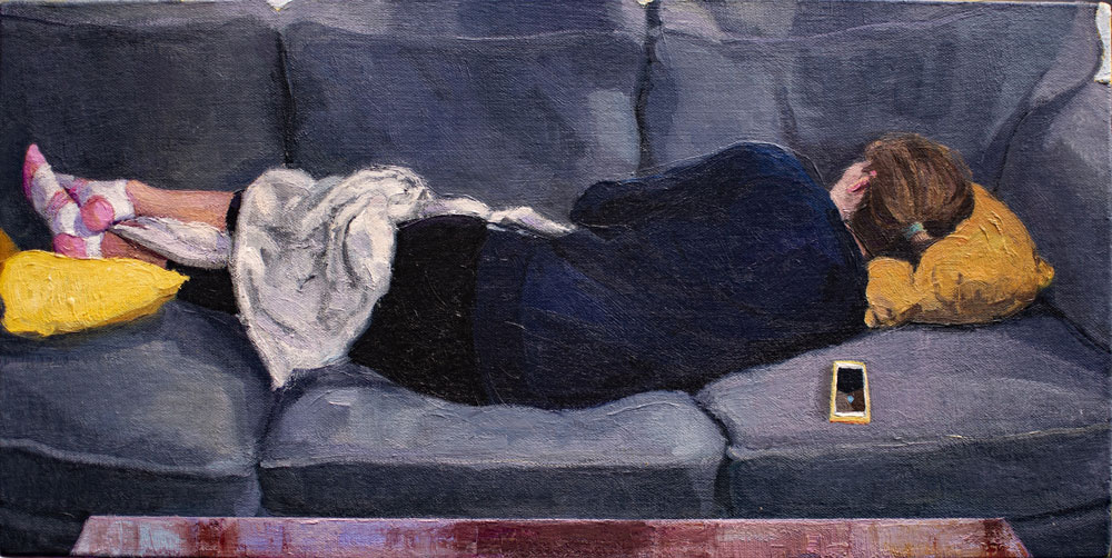 woman asleep on couch with phone