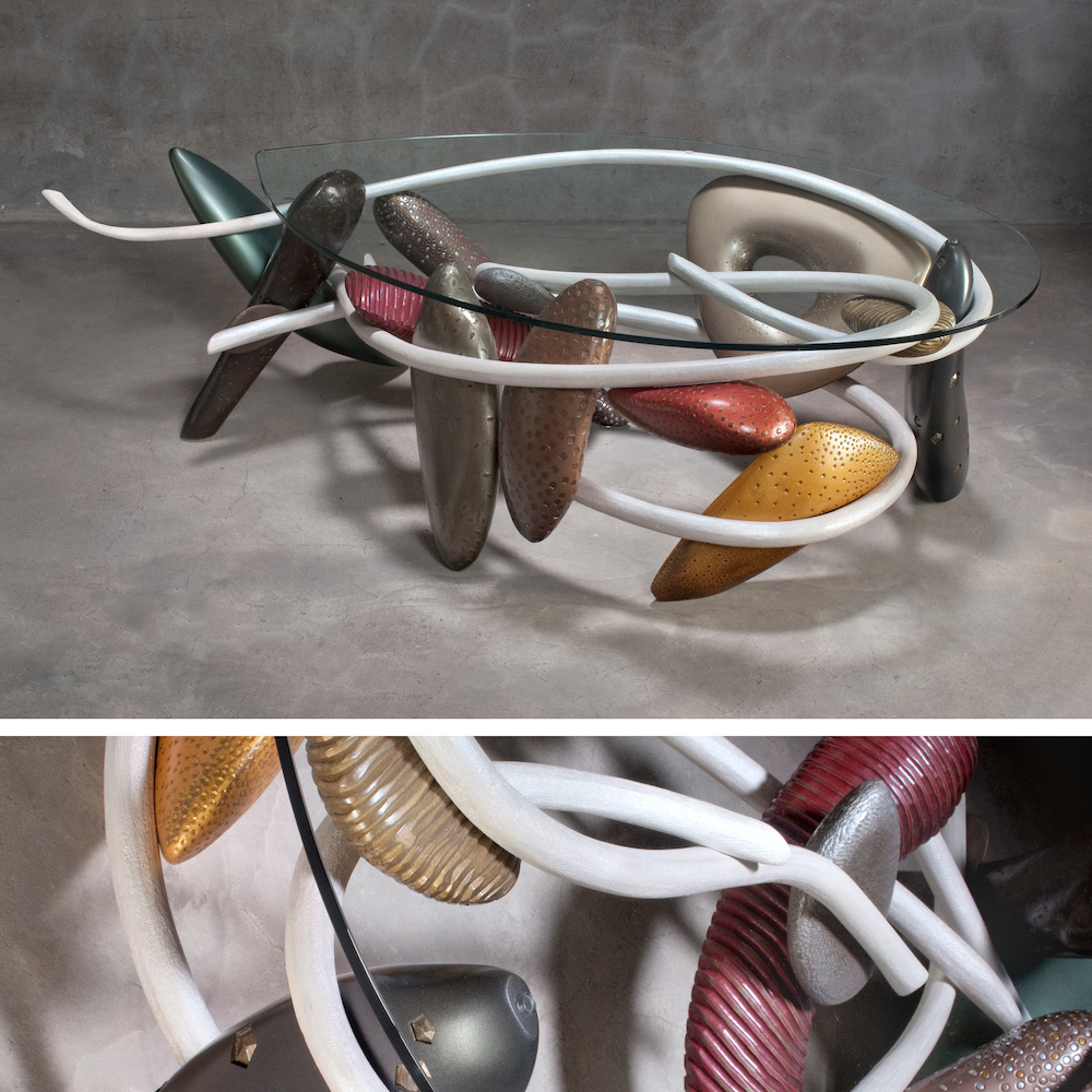 glass table with curving wooden lines and carved boulders