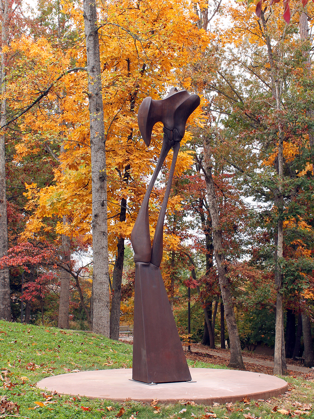 Rusted metal bone-like sculpture in autumn background