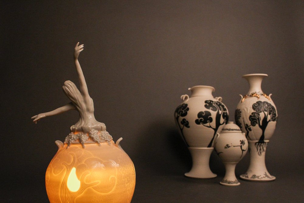 Figure emerging from ceramic vessel with other ceramic vessels in background