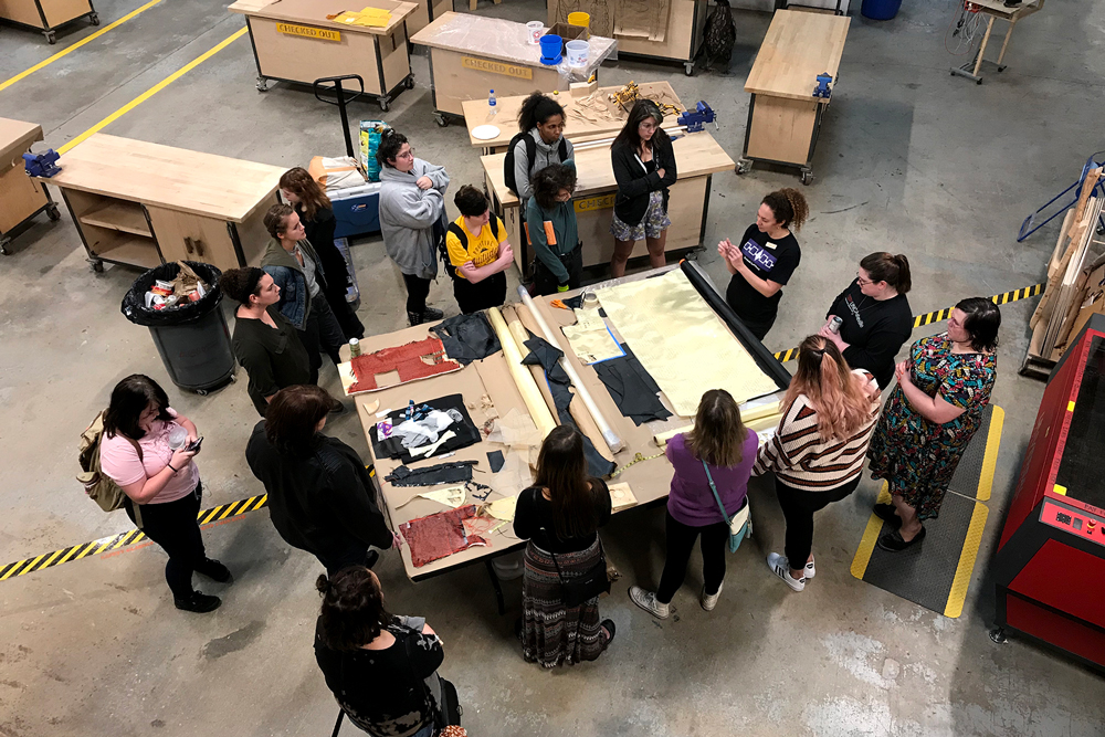 Top view of Erika Diamond speaking to group of students about her materials and process