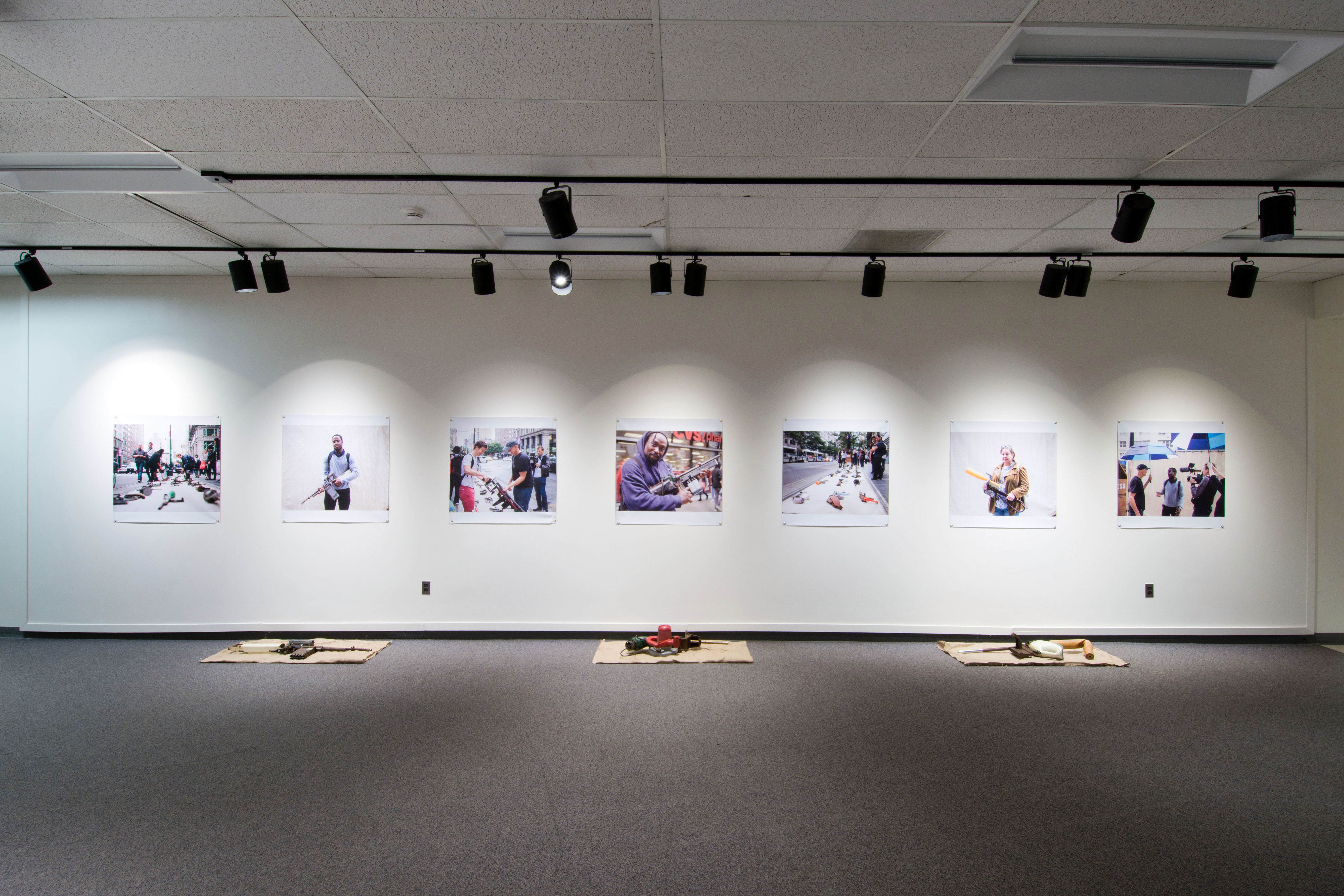 Exhibition of mock assault rifles and images displayed in second floor gallery of Owen Hall