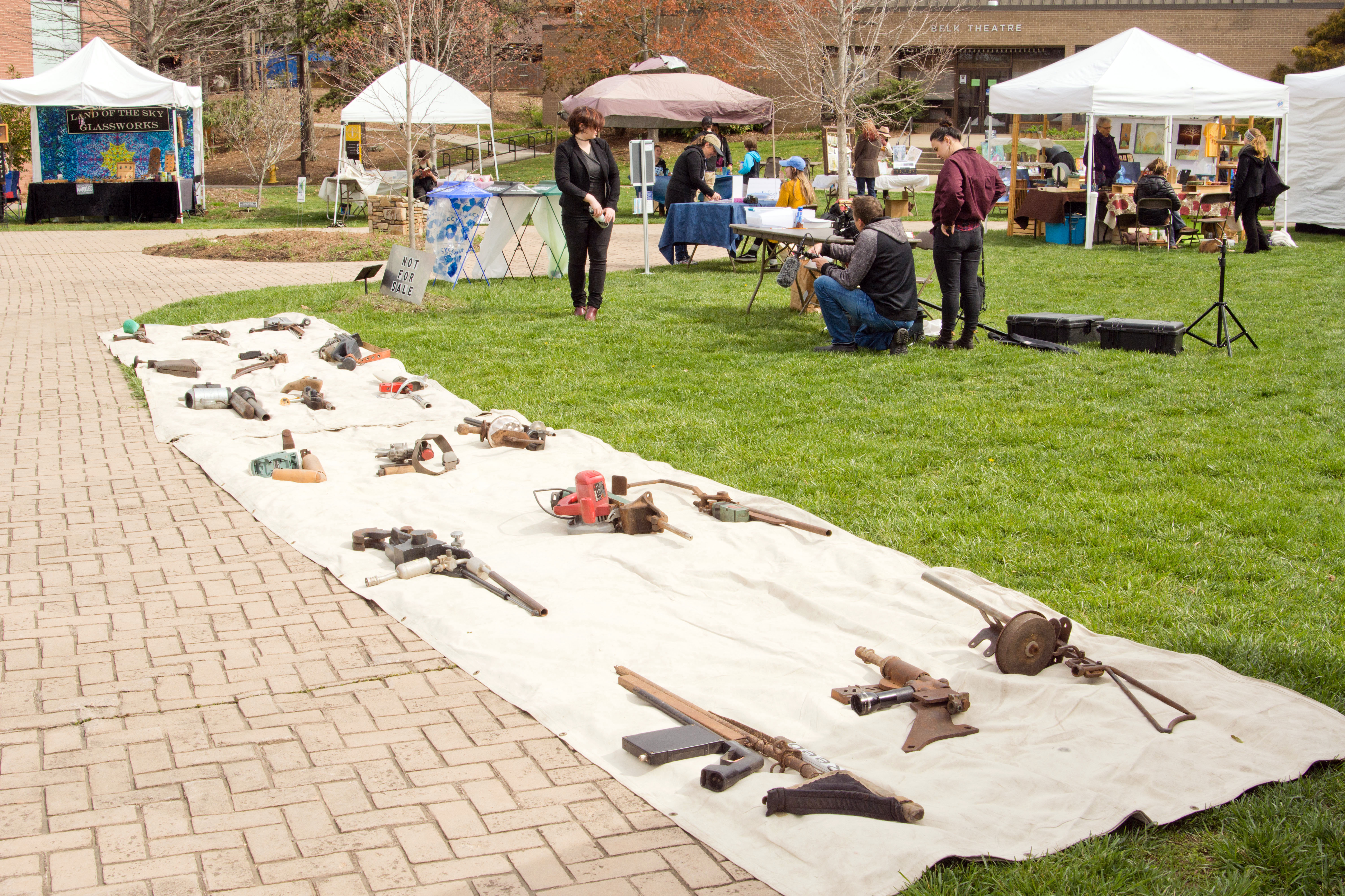 Mock assault rifles lay on tarps on UNCA min-quad